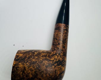 May include: A tobacco pipe with a dark brown and black mottled finish. The pipe has a curved shape with a black mouthpiece. The bowl and stem are a warm brown color with dark brown marbling.