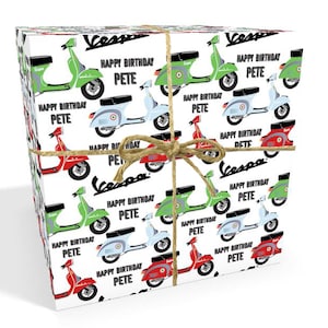 May include: A white gift wrap with a repeating pattern of colorful Vespa scooters. The scooters are green, red, blue, and gray. The text "Happy Birthday Pete" is repeated throughout the pattern.