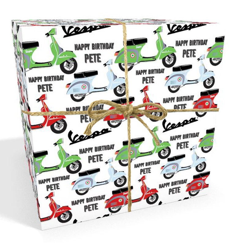 May include: A white gift wrap with a repeating pattern of colorful Vespa scooters. The scooters are green, red, blue, and gray. The text "Happy Birthday Pete" is repeated throughout the pattern.
