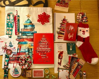 May include: A festive collection of Christmas-themed items, including a tote bag with a book tree design, a red snowflake, a book, a notebook, a Santa sock, and various ornaments. The image also features the text "All I want for Christmas is more BOOKS."