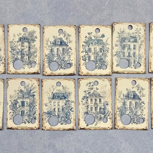 Könnte beinhalten: Zwölf rechteckige Etiketten mit einem blauen und weißen Toile-Muster, das ein Haus mit Garten zeigt. Jedes Etikett hat oben ein Loch.