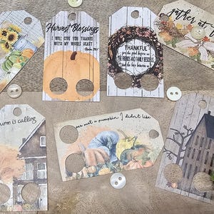 May include: Set of ten autumn-themed gift tags with a rustic design. Each tag features a different image, including pumpkins, a house, and a harvest scene. The tags have holes punched in them for string or ribbon.
