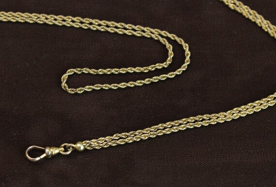 ANTIQUE 48-inch twisted link watch chain, with “dog c… - Gem
