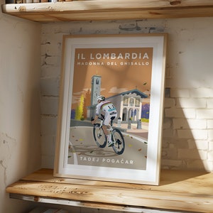 May include: A vintage-style poster featuring a cyclist riding a bicycle up a hill towards a church. The poster is titled "IL LOMBARDIA MADONNA DEL GHISALLO" and features the name "TADEJ POGAČAR" at the bottom.