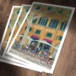 Velocafe prints laid on wooden table.
