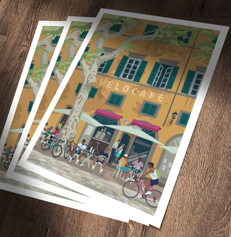 Velocafe prints laid on wooden table.