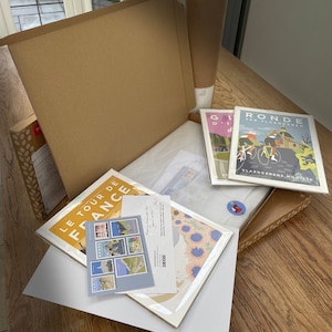 Example of packaging used by JensCyclingArt. Prints shown in plastic-free cello envelopes and tissue paper ready for packing into eco-friendly cardboard boxes, envelopes or postal tubes. Handwritten note from seller and free postcard included.
