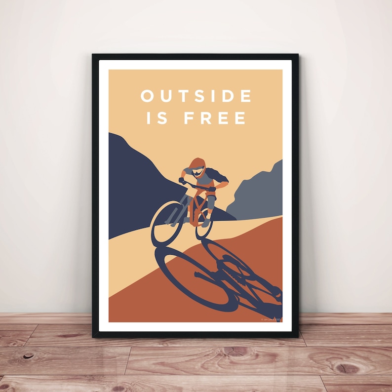 May include: A poster with a mountain biking illustration and the text "OUTSIDE IS FREE". The poster has a brown, orange, and blue color scheme.