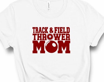May include: White t-shirt with red text that says "Track & Field Thrower Mom" with a red shot put graphic.