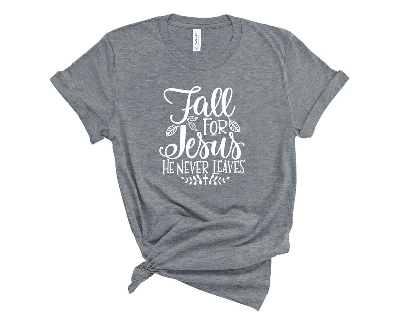 May include: Gray t-shirt with white text that reads "Fall for Jesus He Never Leaves" with a small leaf design.