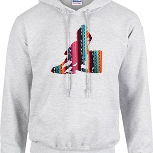 May include: A grey hooded sweatshirt featuring a colourful graphic of a person riding a horse. The graphic has a southwestern pattern.