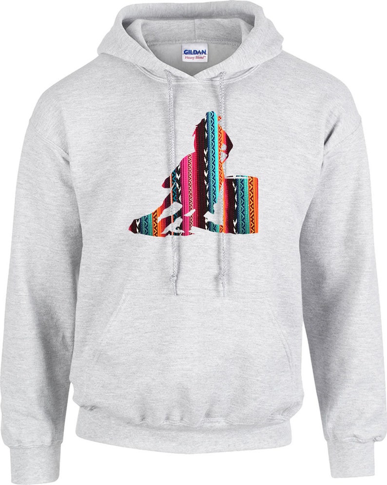 May include: A grey hooded sweatshirt featuring a colourful graphic of a person riding a horse. The graphic has a southwestern pattern.