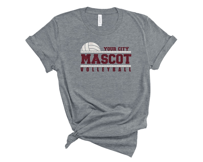 May include: Gray t-shirt with a volleyball graphic and the text "YOUR CITY MASCOT VOLLEYBALL" in maroon.