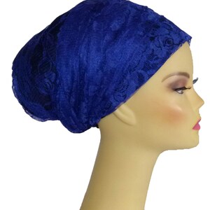 May include: A royal blue lace head covering with a floral pattern.