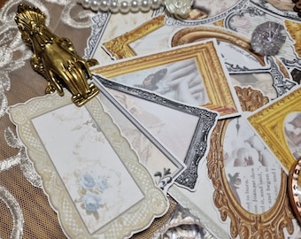May include: A collection of vintage-style paper ephemera, including framed images and a golden hand-shaped clip. The frames vary in style, with gold and silver accents. Some images feature floral designs and soft color palettes. A pearl necklace and a crystal-like object are also present.