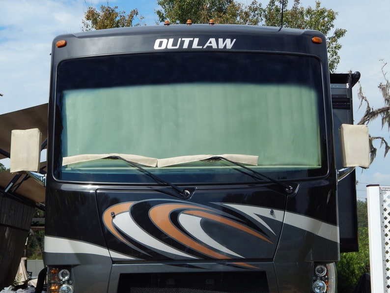 Class A motorhome windshield with interior RV privacy shade installed.