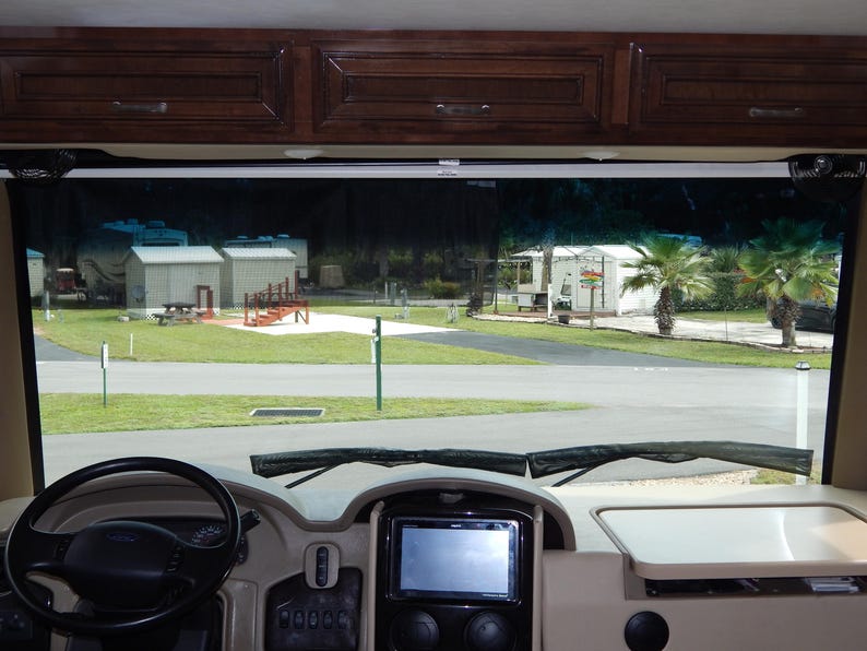 Interior RV windshield privacy shade installed on a Class A motorhome windshield.