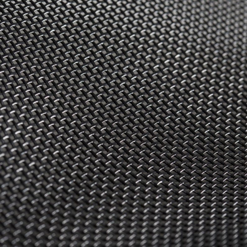 May include: Close-up of a black woven mesh fabric with a repeating pattern. The texture has a subtle sheen, with small, light-colored highlights creating a grid-like appearance. The weave is tight and uniform.