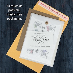 May include: A brown paper envelope containing a translucent paper sleeve with sheep illustrations and a white card that reads: THIS CARD NOT ONLY SAYS Thank you IT ALSO PROVES I HAVE EXCELLENT MANNERS. The envelope has a strip with Xcxpark branding.
