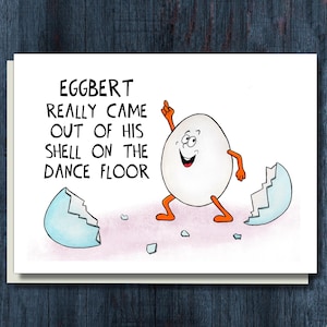 May include: A greeting card with a cartoon egg character, Eggbert, dancing on a white background. The egg is white with orange arms and legs, and the broken eggshell is light blue. Text reads, "EGGBERT REALLY CAME OUT OF HIS SHELL ON THE DANCE FLOOR."