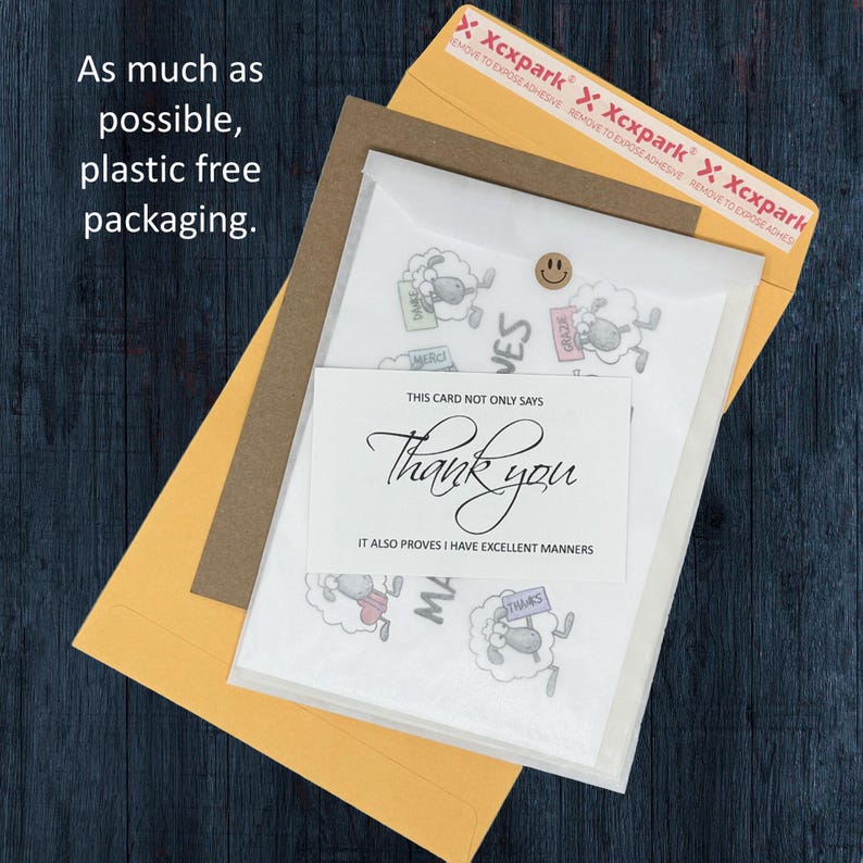 May include: An assortment of stationery items, including a thank you card with elegant script and a sheep illustration. The packaging includes a yellow envelope, a brown envelope, and a clear plastic sleeve. The text on the card reads "Thank you".