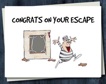 May include: A white greeting card featuring a cartoon illustration of a prisoner in a black and white striped uniform running away from a broken wall with bent bars. The text CONGRATS ON YOUR ESCAPE is printed in black at the top of the card.