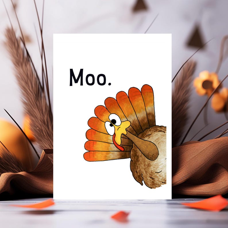 May include: A white greeting card featuring a cartoon turkey with orange and brown tail feathers, a yellow beak, and wide eyes. The text 'Moo.' is printed in black in the upper left corner of the card, which is positioned against a blurred background.