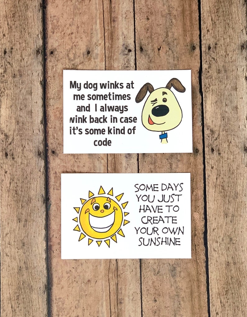 K&ouml;nnte beinhalten: Zwei wei&szlig;e Karten mit schwarzem Text und Illustrationen. Die obere Karte zeigt einen winkenden Cartoon-Hund und den Text "Mein Hund zwinkert mir manchmal zu und ich zwinkere immer zur&uuml;ck, falls es sich um eine Art Code handelt". Die untere Karte zeigt eine Cartoon-Sonne mit einem breiten L&auml;cheln und den Text "Manchmal muss man einfach seinen eigenen Sonnenschein schaffen".