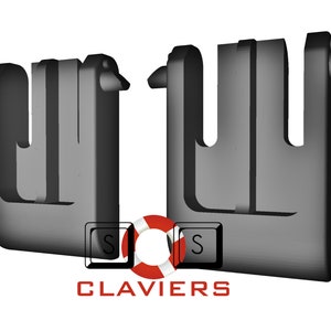 Puede incluir: Dos clips de plástico negro con un diseño en forma de U. Los clips están diseñados para sujetar objetos juntos.