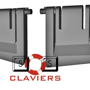 May include: Two gray plastic door hinges with a rectangular shape and a small opening in the center. The hinges are attached to a white background.