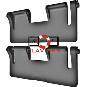 May include: Two black plastic sun visor clips, stacked on top of each other. The top clip is partially obscured by the bottom clip. The word "CLAVIERS" is printed in white letters on the bottom clip.
