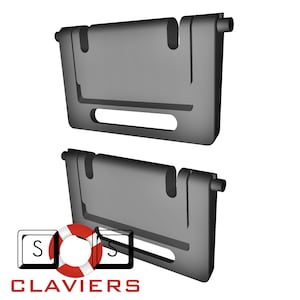 May include: Two black plastic wall-mounted knife holders with a slot for holding knives. The holders have a rectangular shape with rounded edges and a small lip on the top.