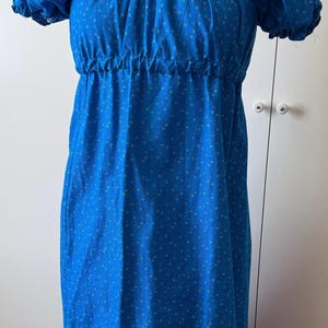 Emma Day Dress - Blue with red and yellow pattern.