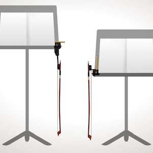 May include: Two gray music stands with white pages, each holding a violin bow and a pencil. The stands have a tripod base. The bows are brown with white hair. The pencils are yellow with a black tip.