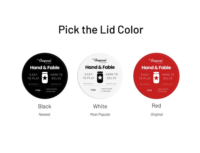 May include: Three round labels with the text "The Original Jar Games" and "Hand & Fable" in black text. The labels are black, white, and red. The text "Black", "White", and "Red" are below the labels. The text "Newest", "Most Popular", and "Original" are below the text "Black", "White", and "Red".