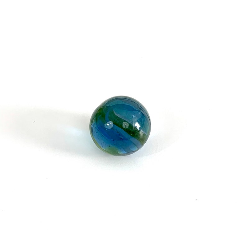 May include: A blue and green glass marble with swirling patterns.