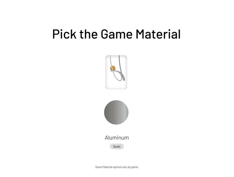 May include: A gray circle with the word "Aluminum" below it. The text "Outlet" is in a gray rectangle below the word "Aluminum". The text "Pick the Game Material" is at the top of the image. A small image of a silver game piece is above the circle.