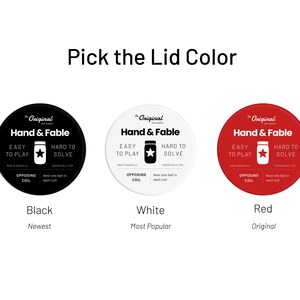 May include: Three round labels with the text "The Original Jar Games Hand & Fable" in black text on a white background. The labels are black, white, and red. The text "Black", "White", and "Red" is below each label. The text "Newest", "Most Popular", and "Original" is below the color names.