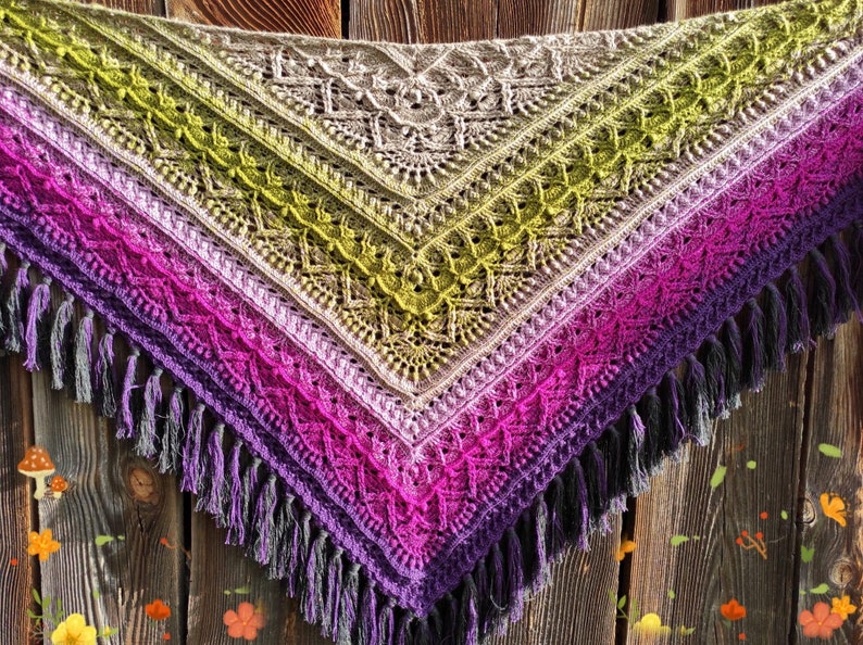 May include: A crocheted shawl with a gradient of green, purple, and pink colors. The shawl has a fringe border and is made with a delicate stitch pattern.