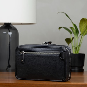 Leather Zippered pouch with interior pockets to store your tech gear like cables, cords, charger and SD Cards. Slim in design, fits easily into a backpack or bag. Keeps all your essentials organized. Beige interior makes it easily to spot items.