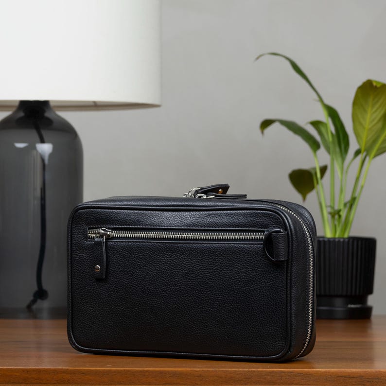 Leather Zippered pouch with interior pockets to store your tech gear like cables, cords, charger and SD Cards. Slim in design, fits easily into a backpack or bag. Keeps all your essentials organized. Beige interior makes it easily to spot items.