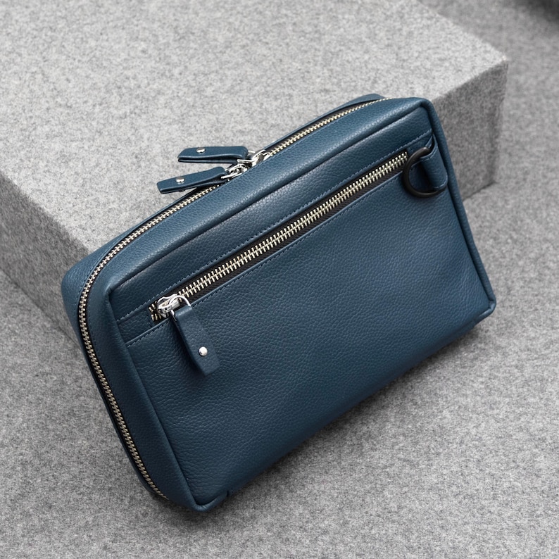 Zippered Tech Pouch in a Cobalt Blue Leather. The Blue Leather along with the silver-colored metallic zippers showcase a superior, refined appearance.