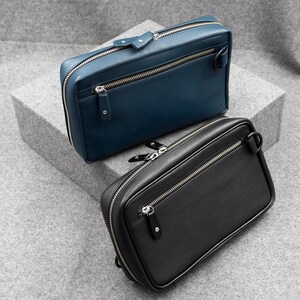 Leather Tech Pouch with a zip around closure, available in two choices of leather. Black pebble grain and blue pebble grain.