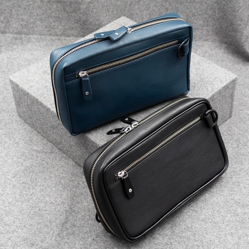 Leather Tech Pouch with a zip around closure, available in two choices of leather. Black pebble grain and blue pebble grain.