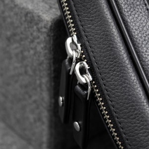 The leather zippered pouch to carry your tech gear is designed with YKK Zippers in a metallic finish.