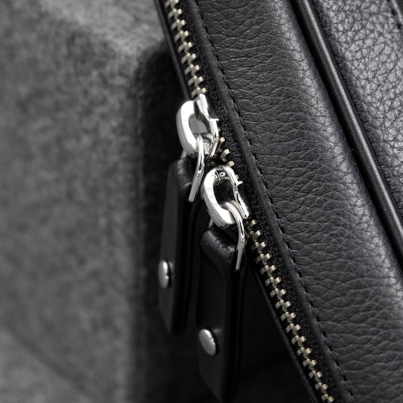 The leather zippered pouch to carry your tech gear is designed with YKK Zippers in a metallic finish.