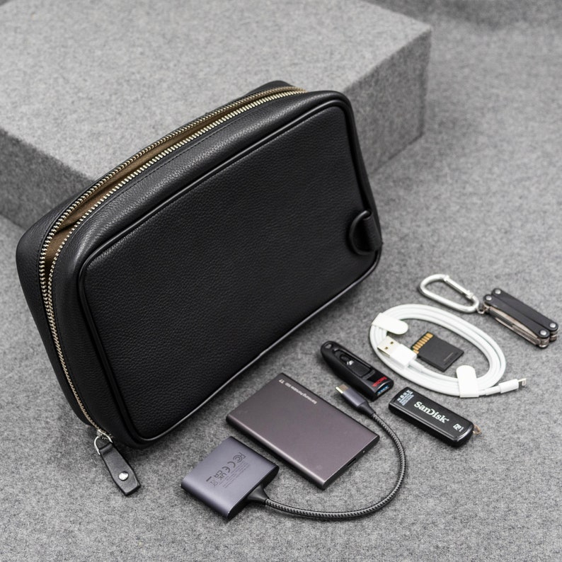 The above image shows the back side of the zippered pouch. There is a D-Ring that along with the D-Ring on the opposite side helps to carry the pouch crossbody.