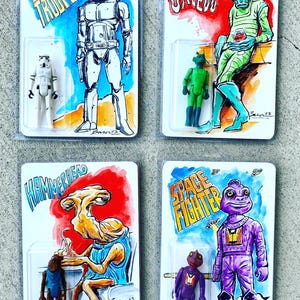 May include: Four Star Wars-themed action figure cards. Each card features a hand-drawn illustration of a character with the character's name in a stylized font. The figures are in clear plastic packaging. Characters include Stormtrooper, Greedo, Hammerhead, and Space Fighter.
