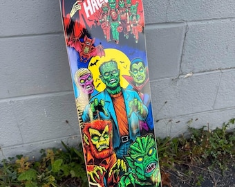 May include: A skateboard deck featuring a colorful graphic of classic horror movie monsters including Frankenstein's monster, a mummy, a werewolf, and a creature from the lagoon, with the text I REMEMBER HALLOWEEN at the top.