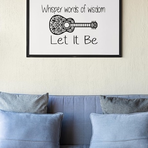 May include: A black framed print with the text "Whisper words of wisdom Let It Be" and a decorative guitar design.